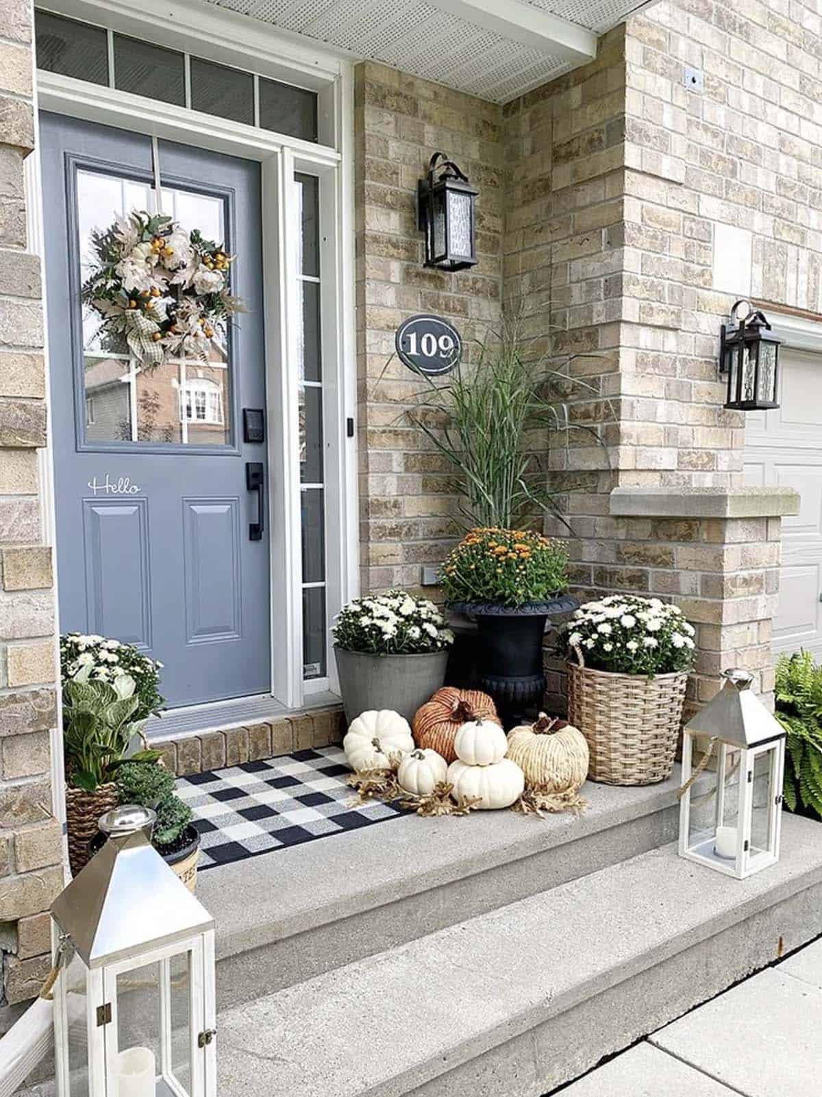 front porch steps with fall decorations and lanterns