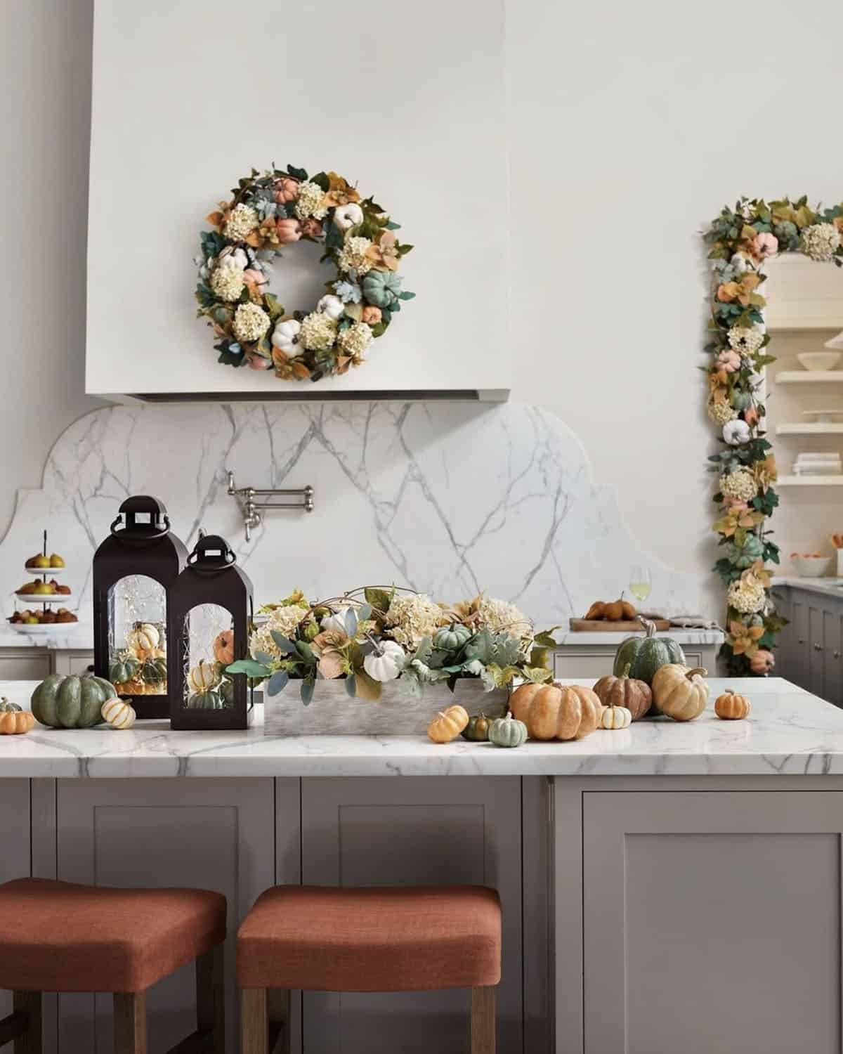 kitchen decorated for fall with pumpkins and lanterns