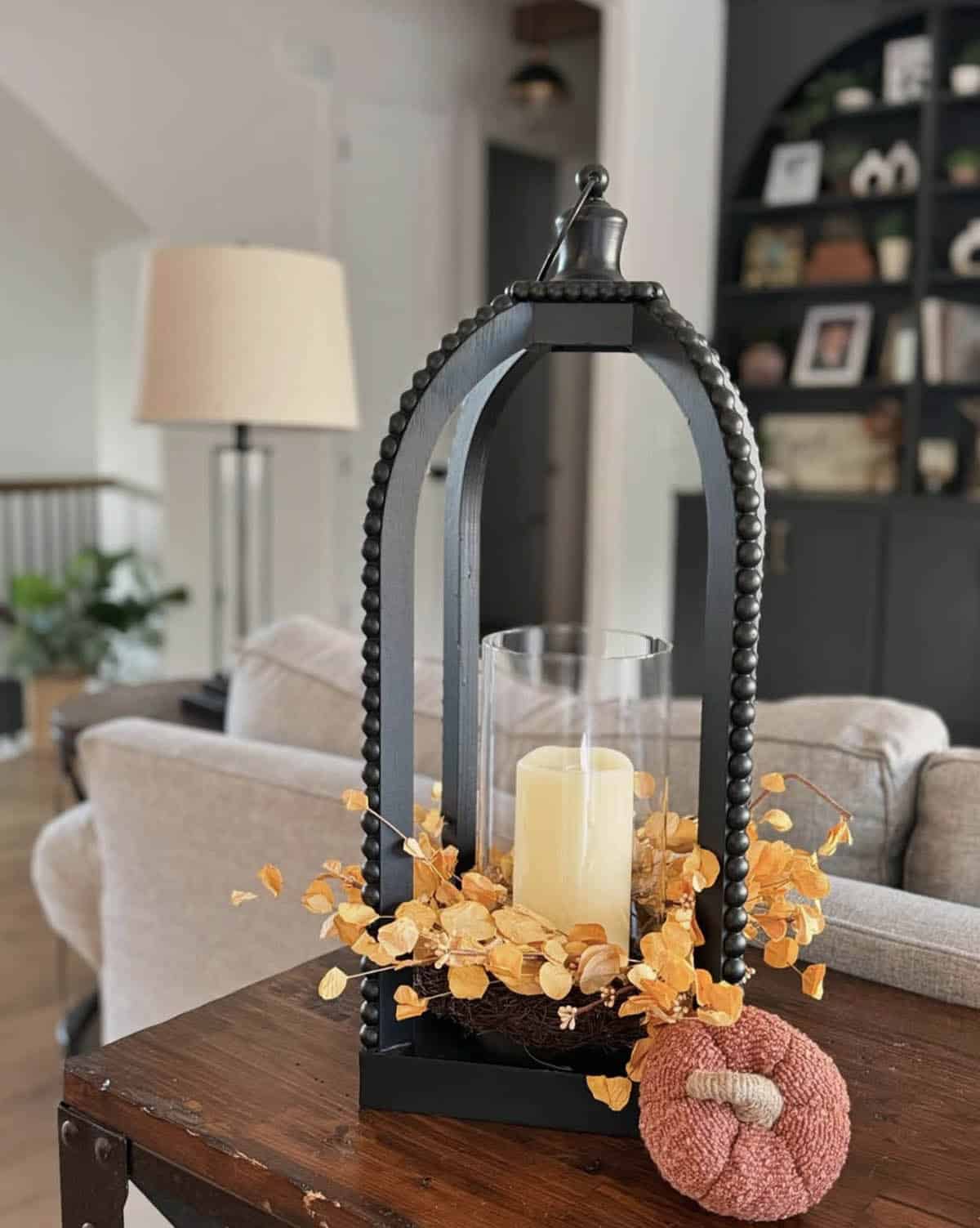fall vignette with a lantern and fall foliage