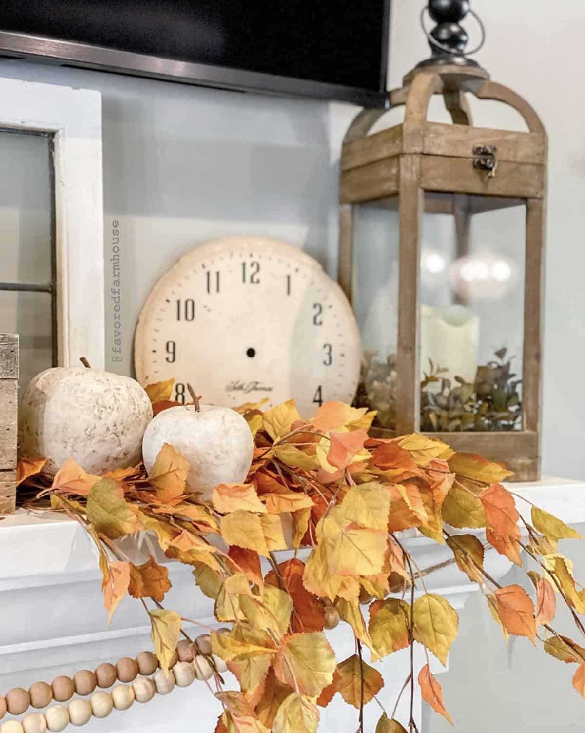 fall lantern on a fireplace mantel in the living room