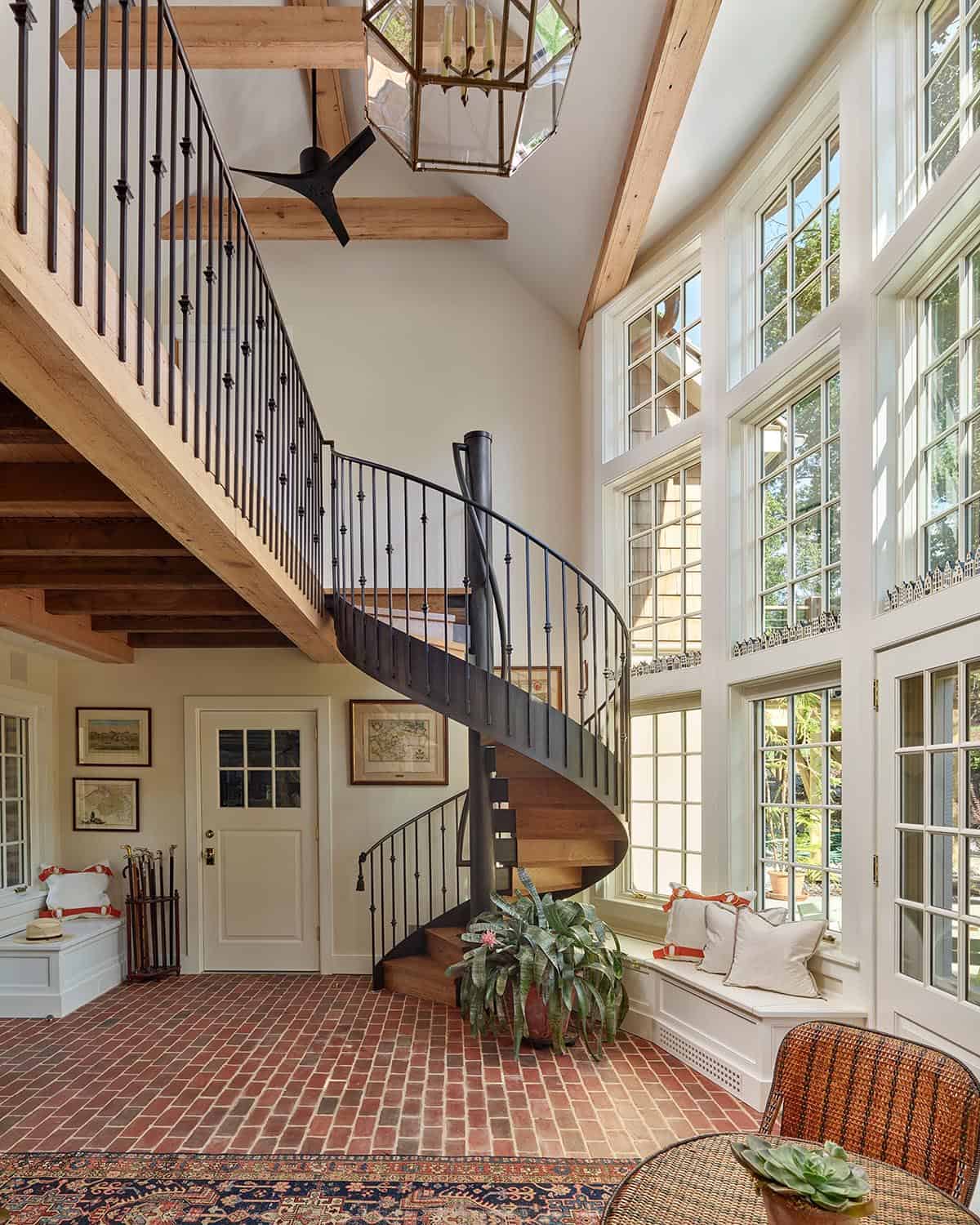 stone cottage with a glassy atrium and spiral staircase