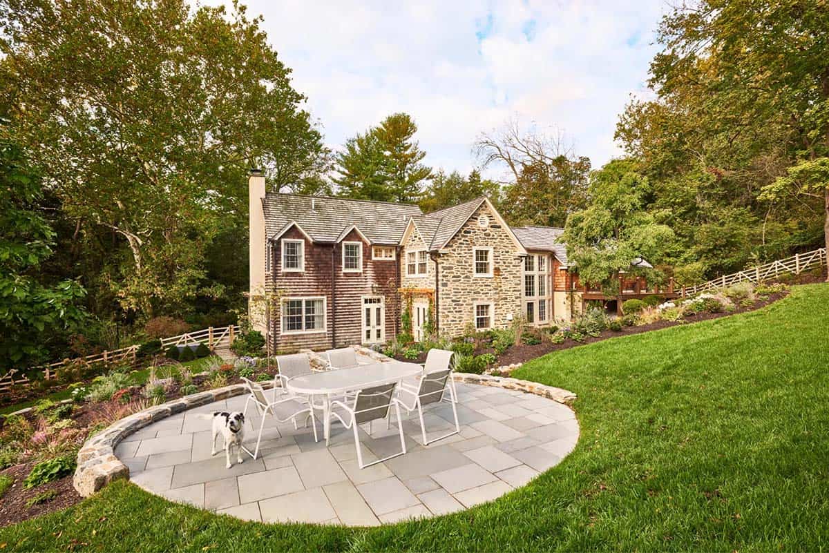 stone house exterior backyard patio with outdoor furniture