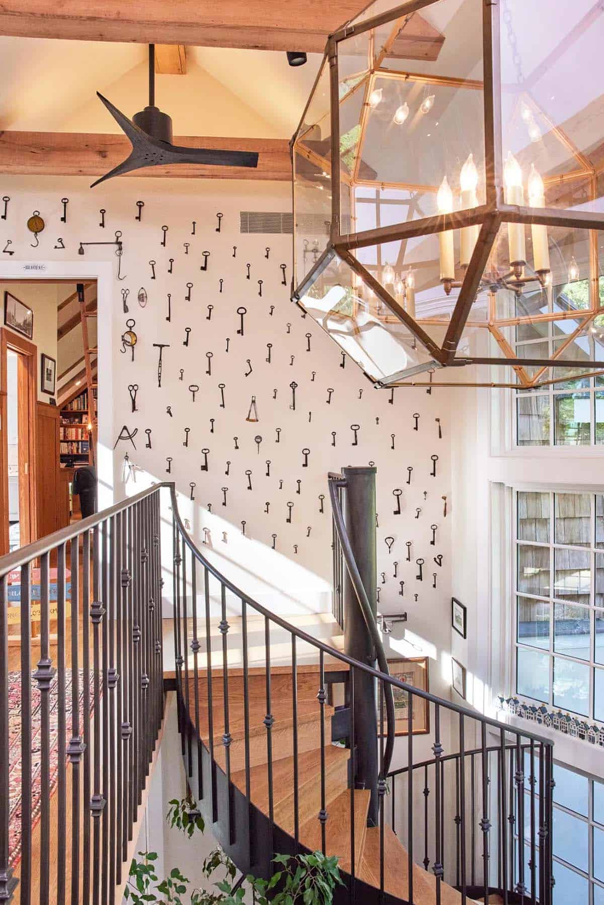 stone cottage with a glassy atrium and spiral staircase