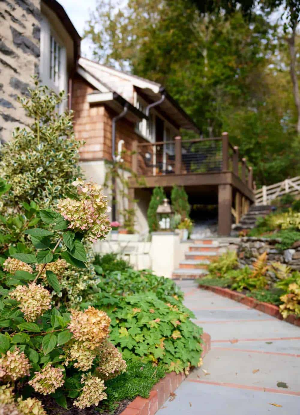 stone house exterior with a pathway and landscaping
