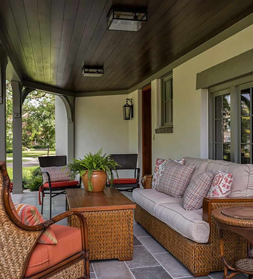 tudor house exterior covered front porch with outdoor furniture
