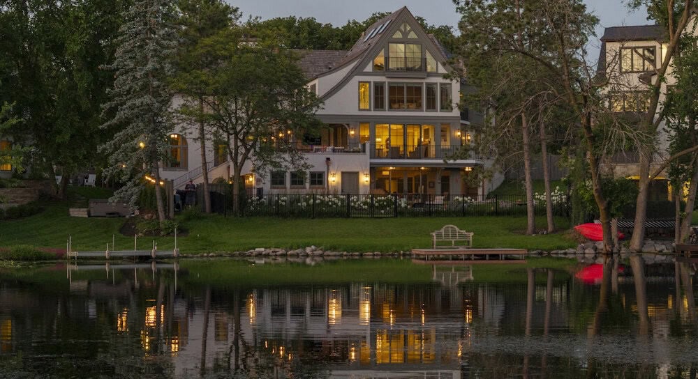 tudor house exterior at dusk with a water view