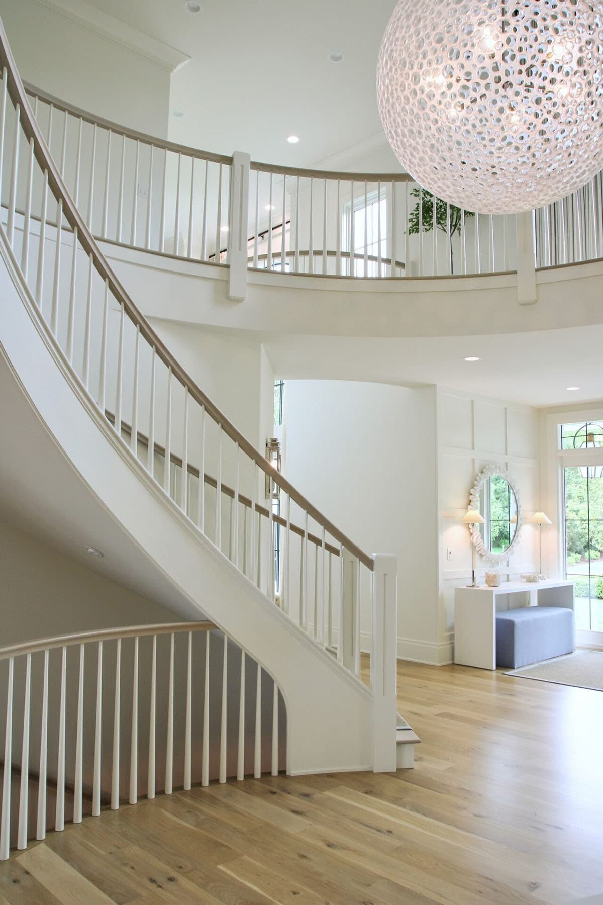 contemporary lake house entry with a grand staircase 