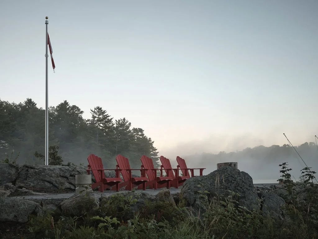 transitional style lake house dock with adirondack chairs