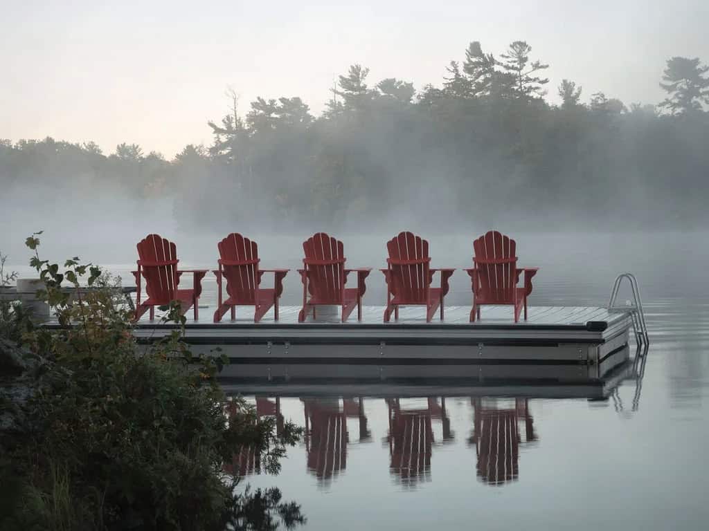 transitional style lake house dock with adirondack chairs