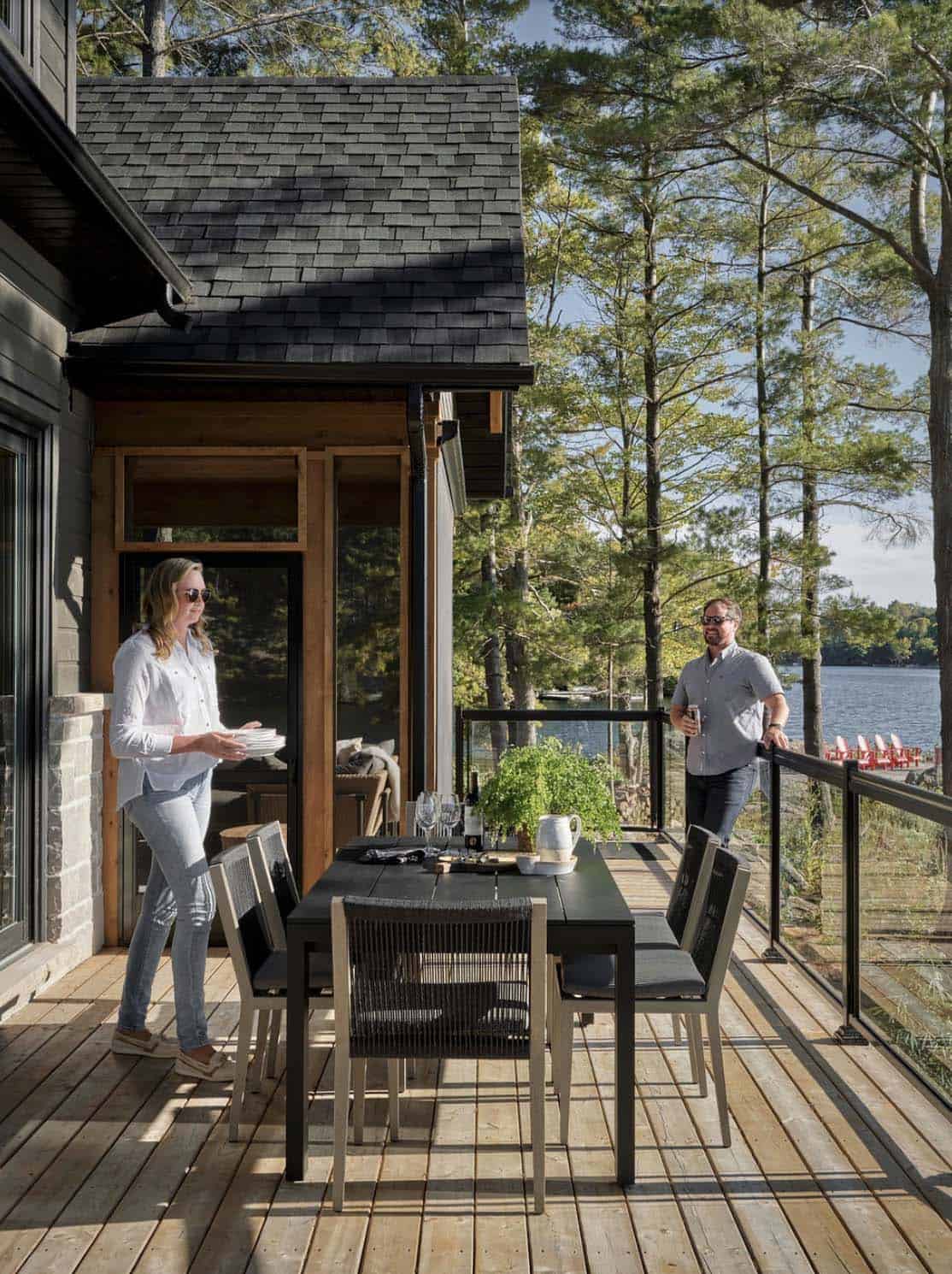 transitional style lake house balcony with a dining table