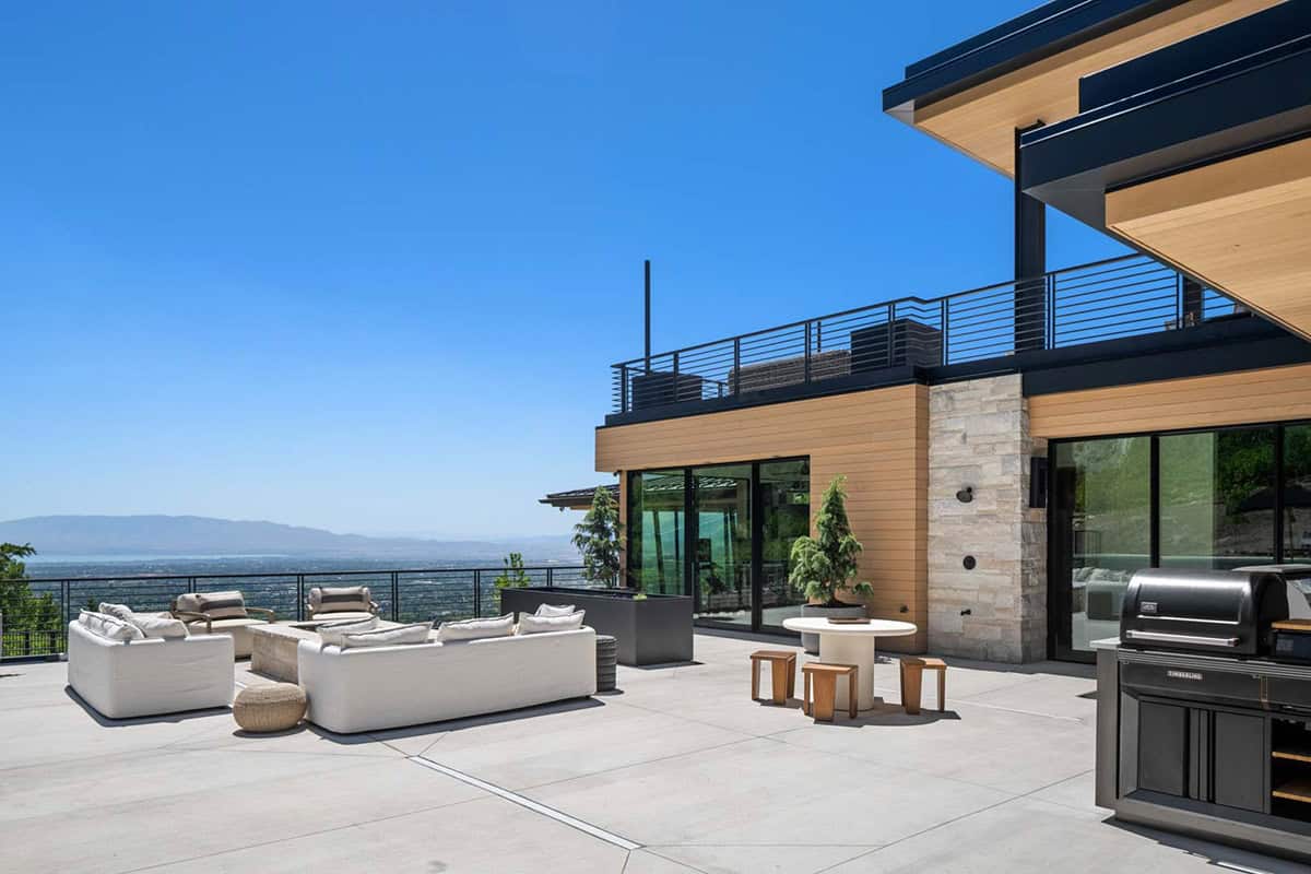 luxury modern home exterior with a patio and outdoor furniture