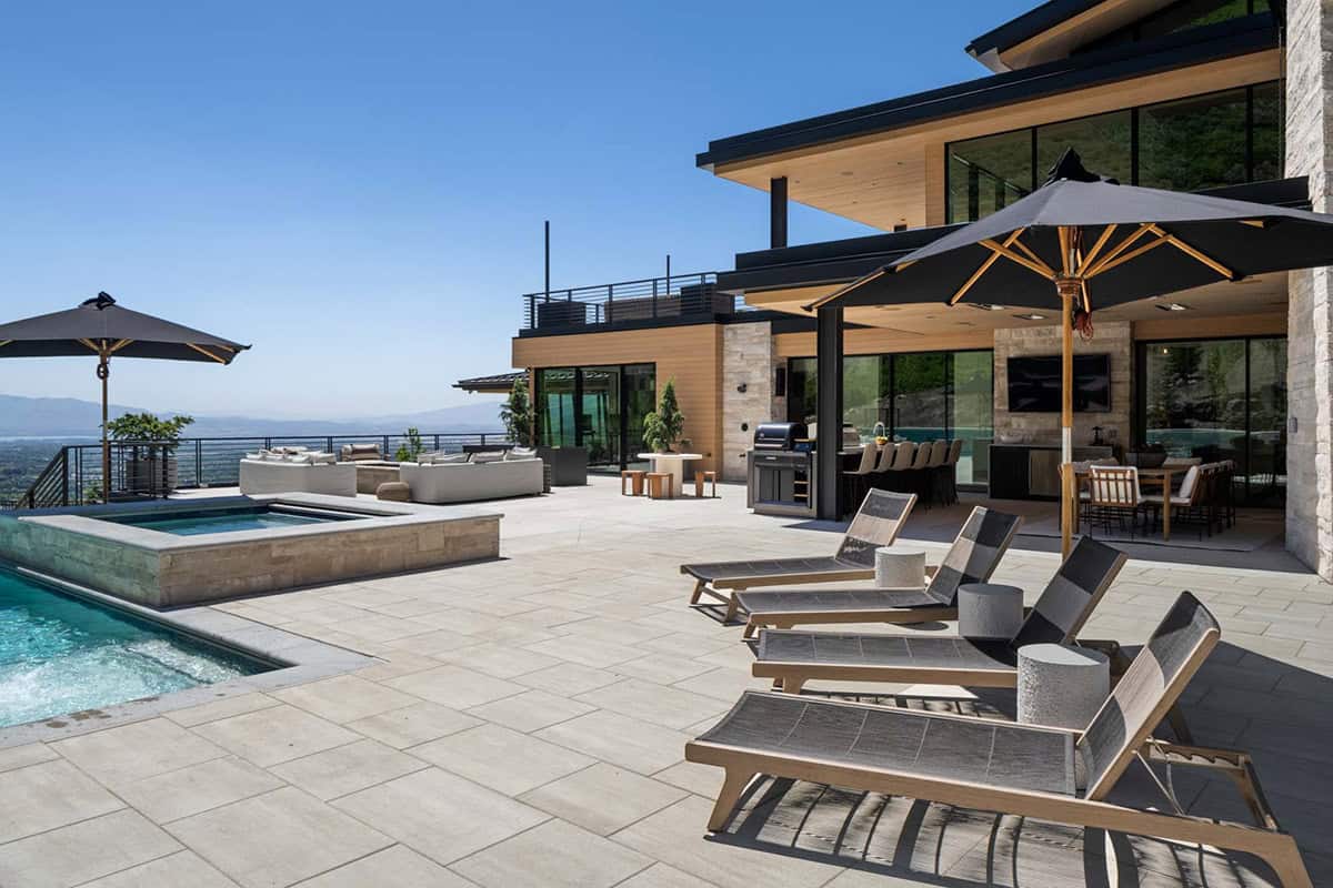 luxury modern home exterior with a patio and outdoor furniture