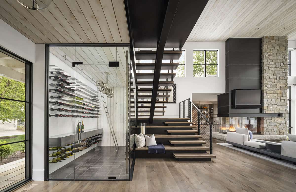modern lake house entry with a wine cellar and staircase