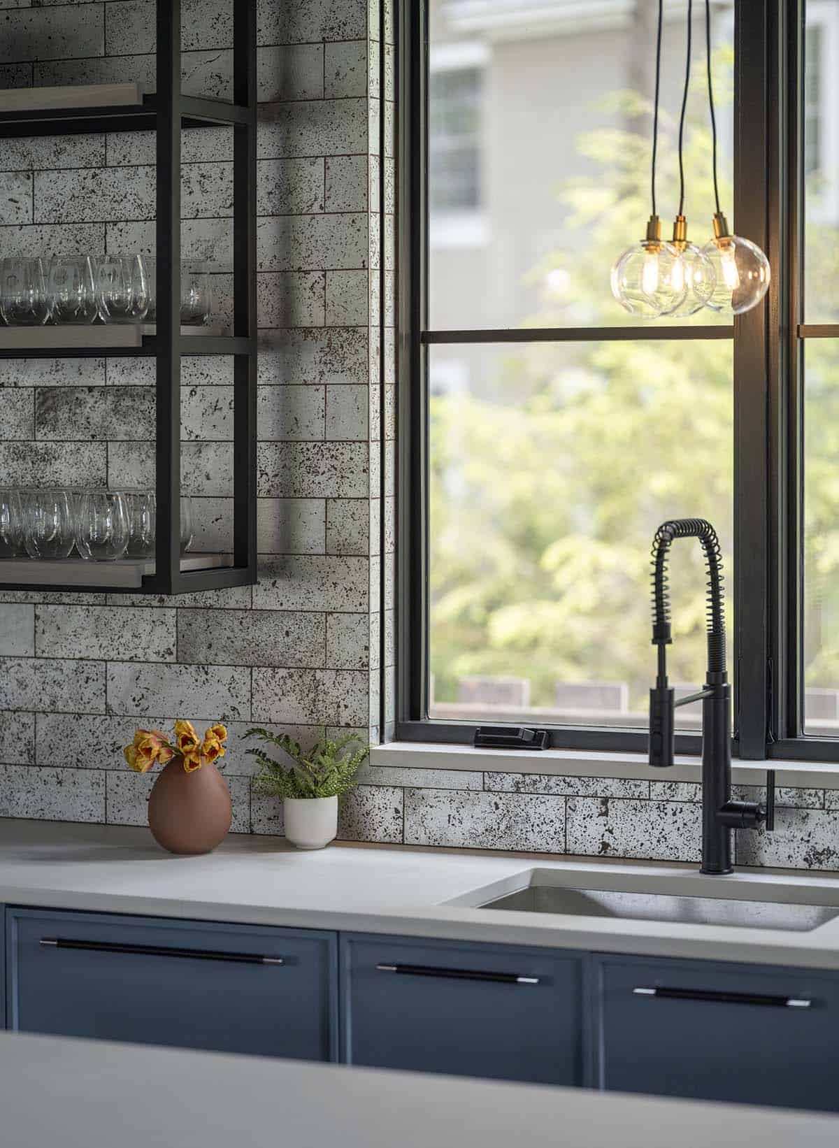 modern guest pavilion kitchen with a sink and floating shelves