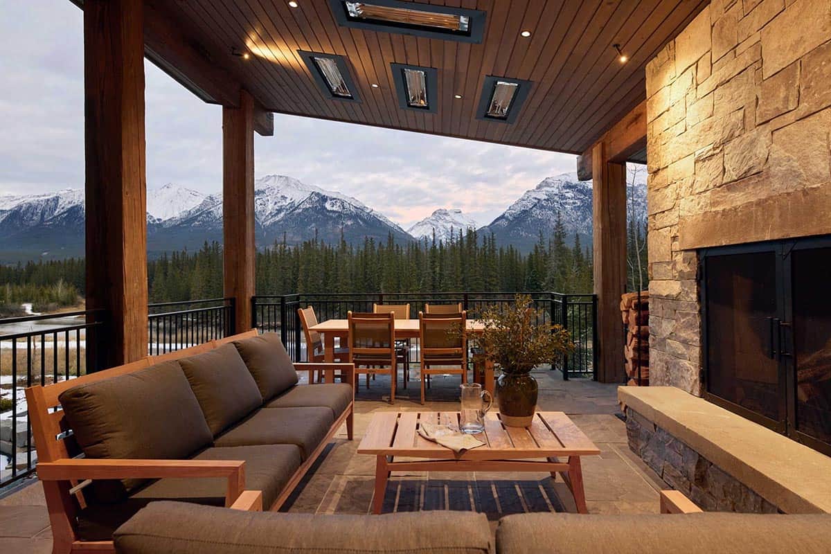 modern mountain house covered patio with a fireplace