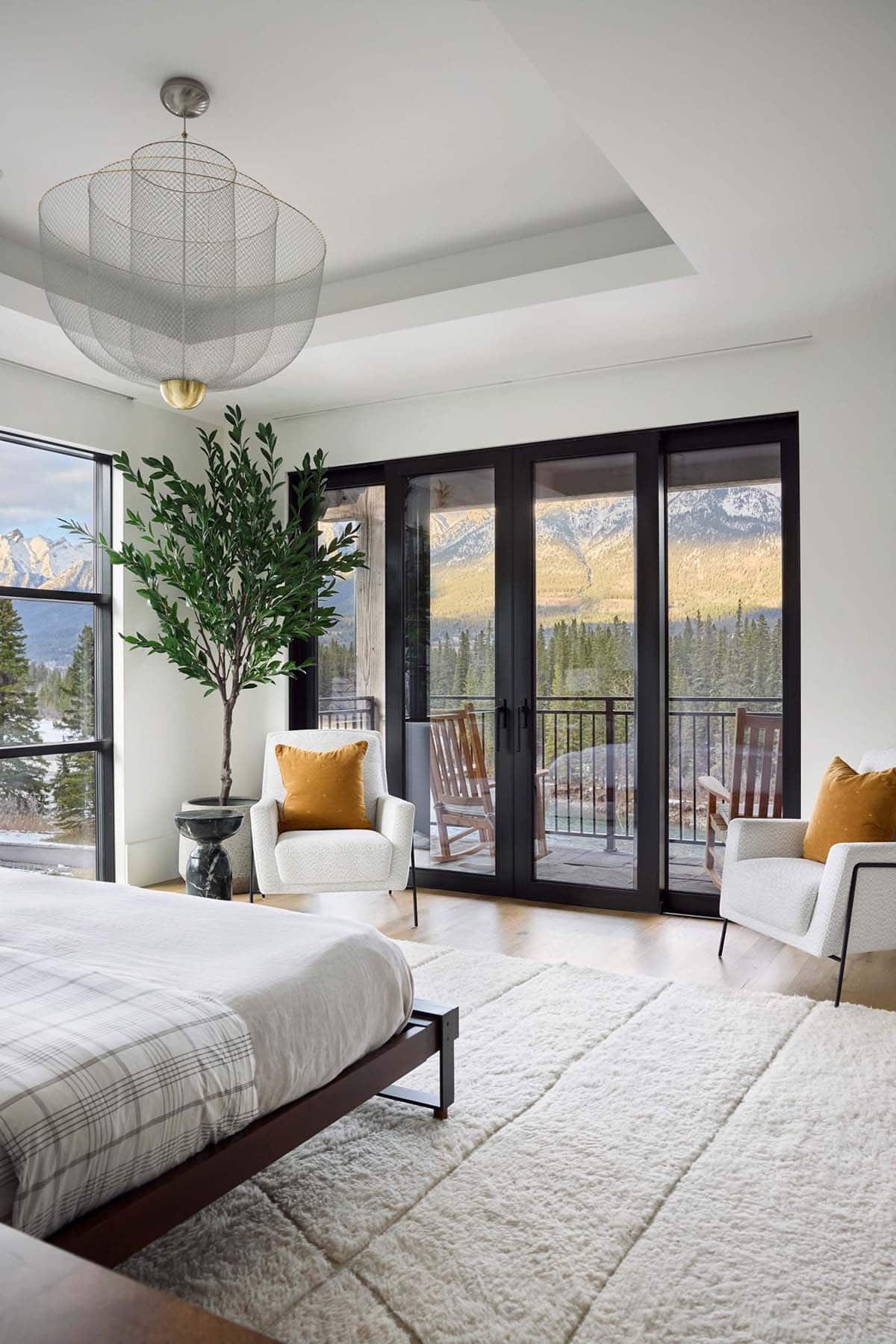 modern mountain style bedroom with large windows