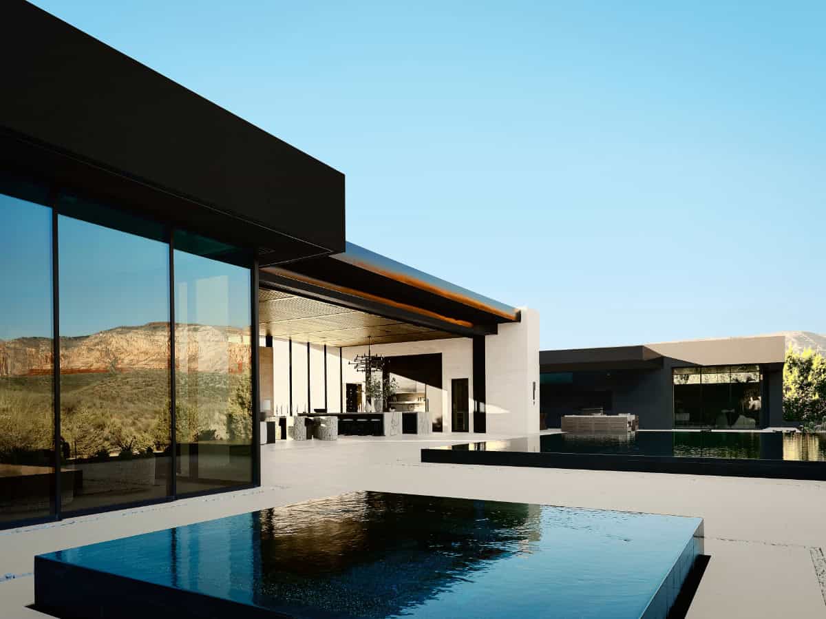 modern mountain home exterior with a pool at dusk