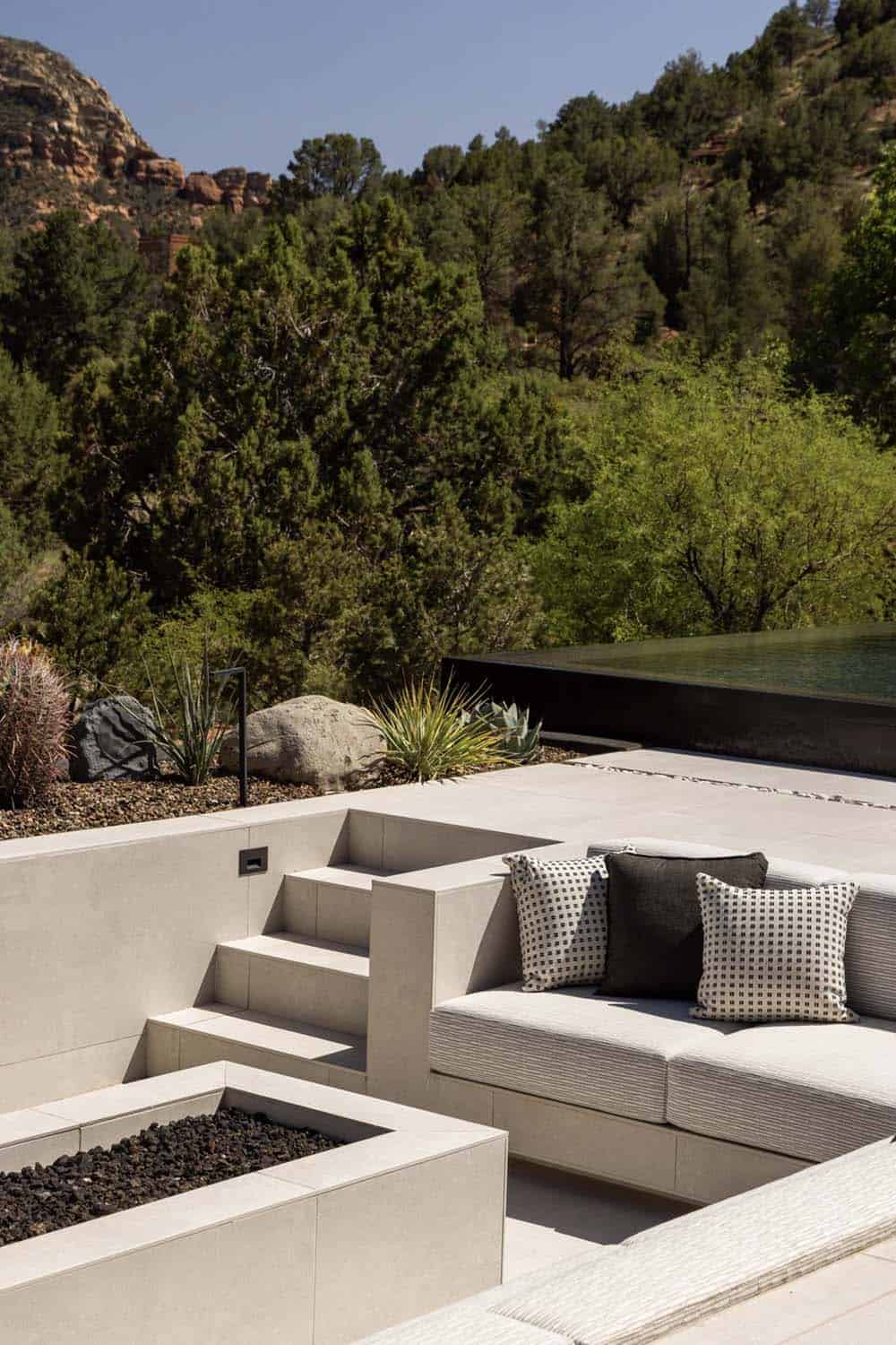 modern mountain home exterior with a patio and fire pit