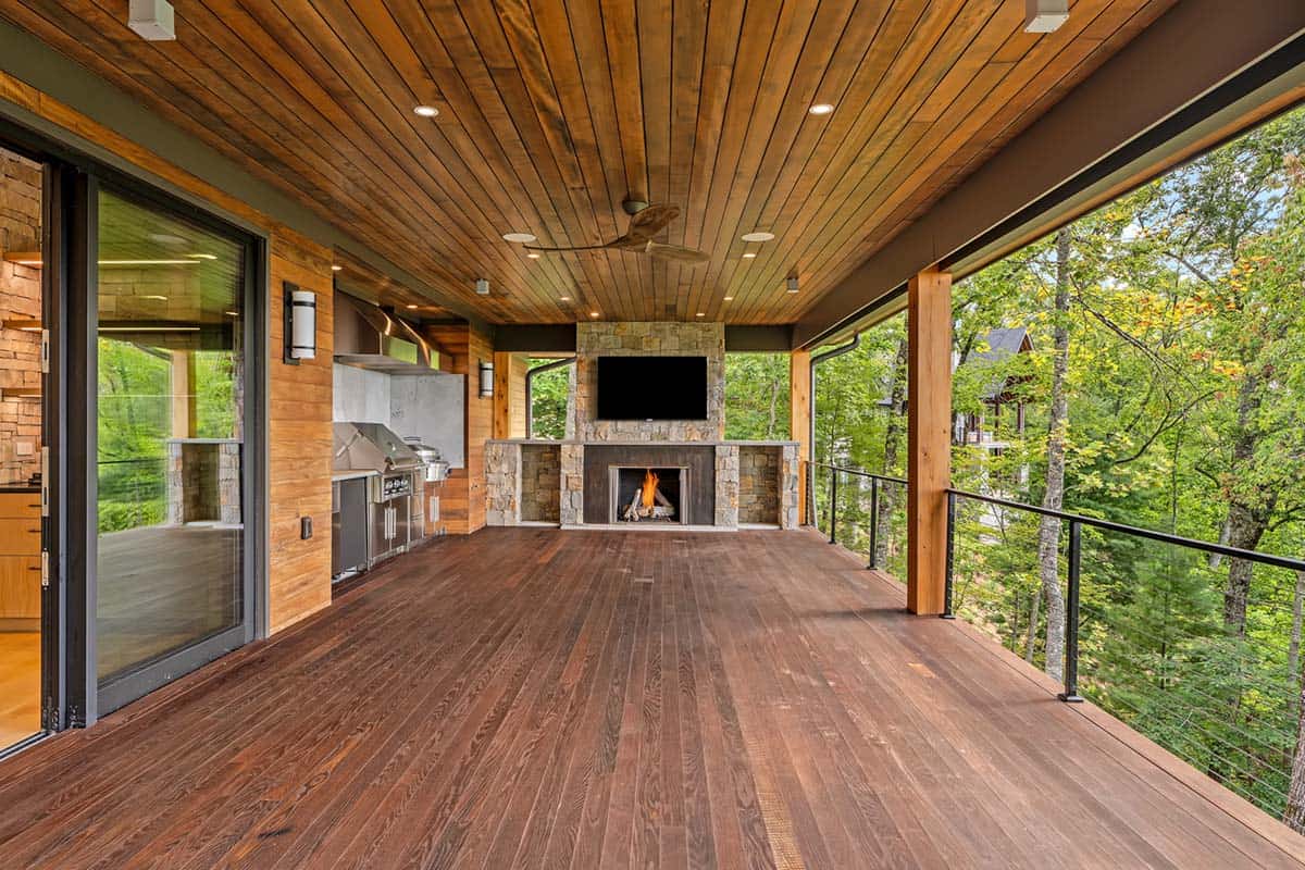 modern covered porch with a fireplace