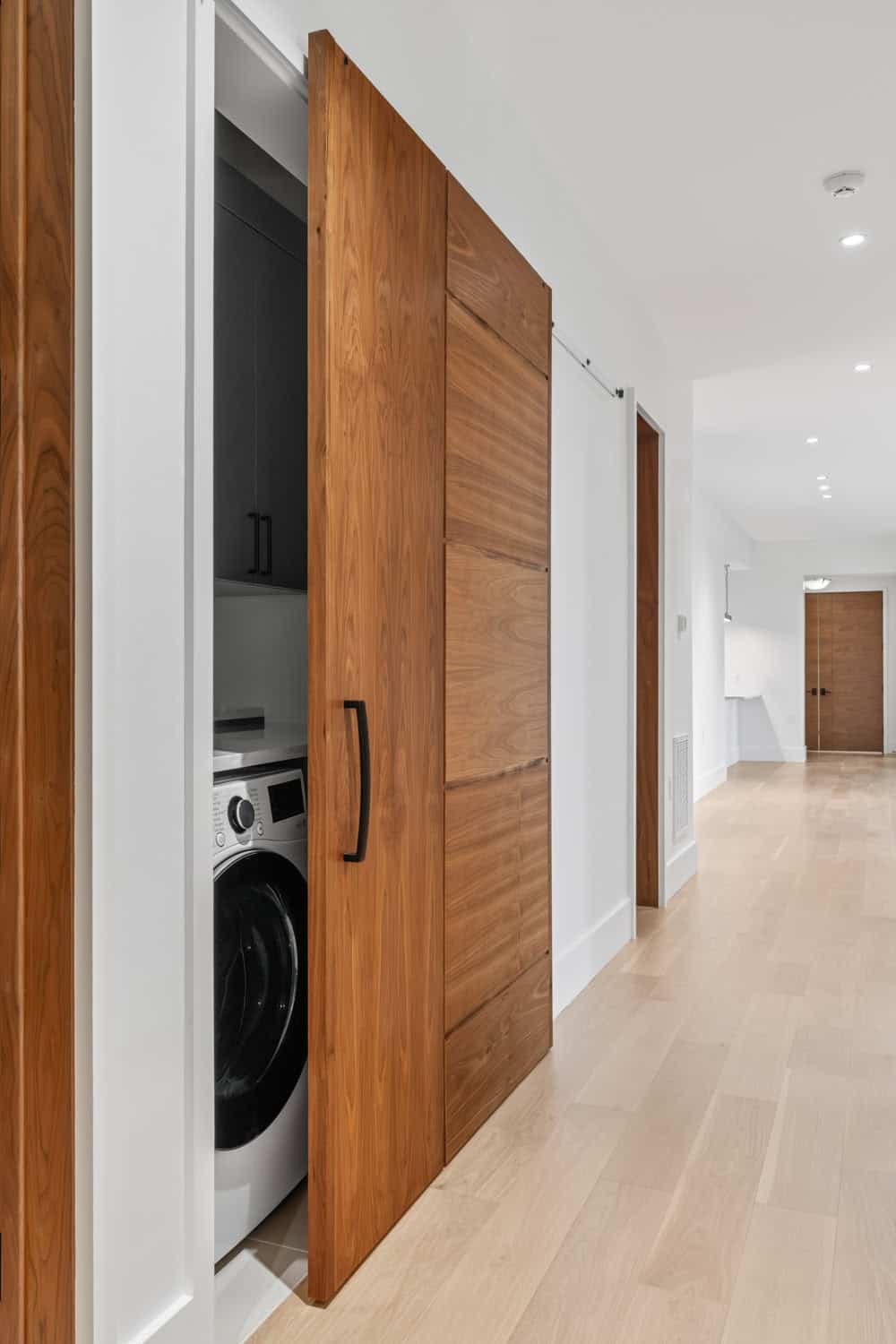 modern laundry room with a sliding barn door