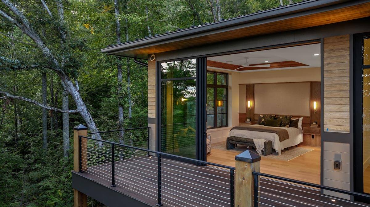modern mountain home exterior with a view of the main bedroom with a private deck