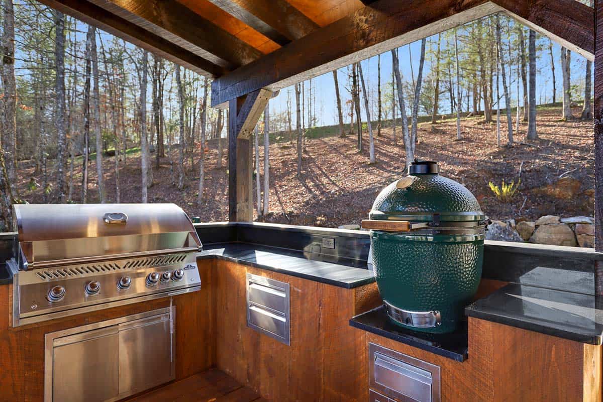 modern rustic log frame cabin porch with an outdoor kitchen