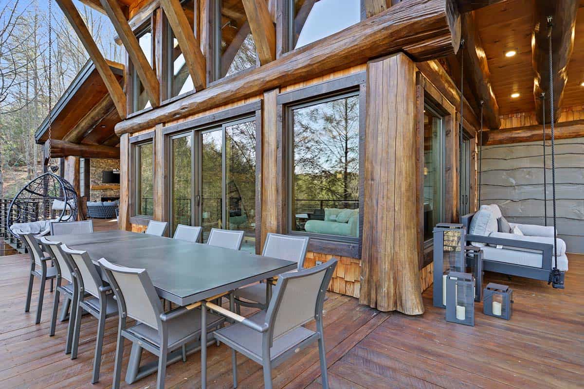 modern rustic log frame cabin porch with outdoor dining
