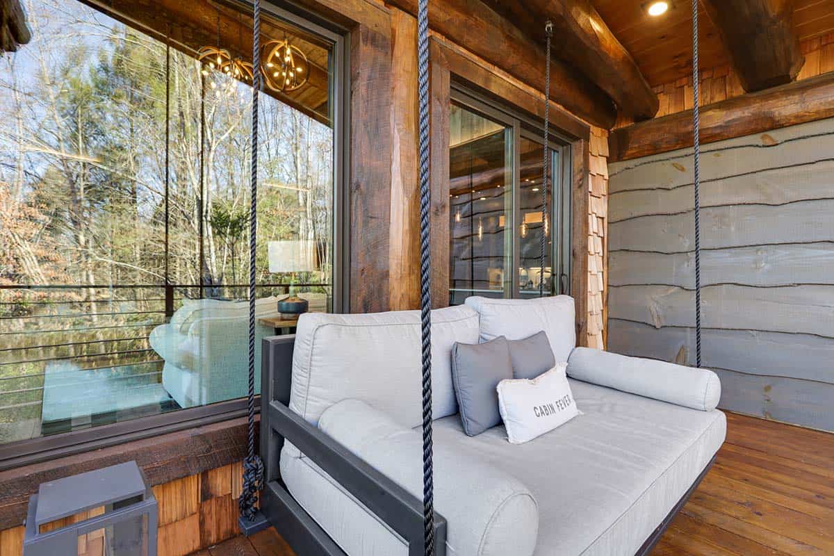modern rustic porch with a hanging daybed