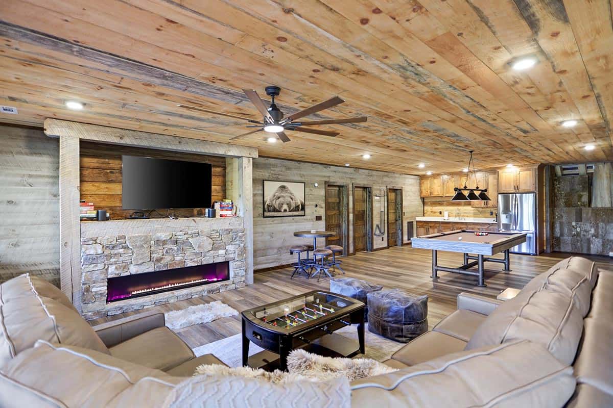 modern rustic lower-level family room with a fireplace
