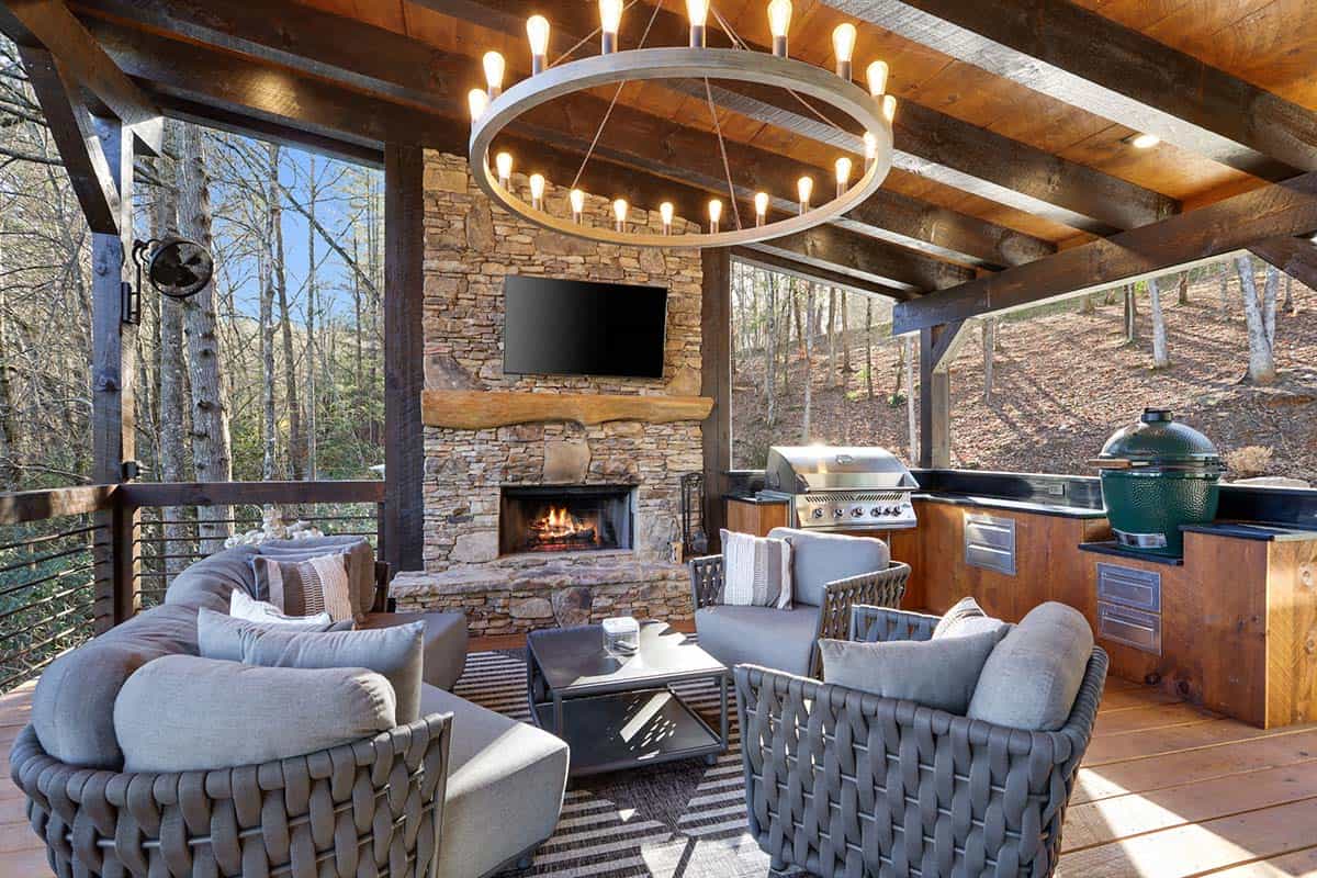 modern rustic covered porch with an outdoor fireplace 