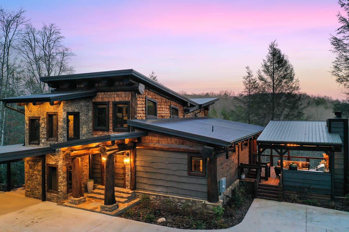 modern rustic log frame cabin exterior at dusk