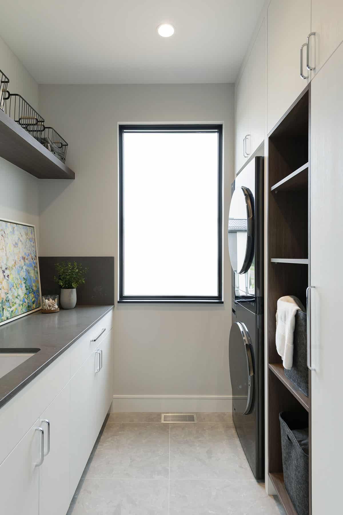 modern laundry room with a stackable washer and dryer