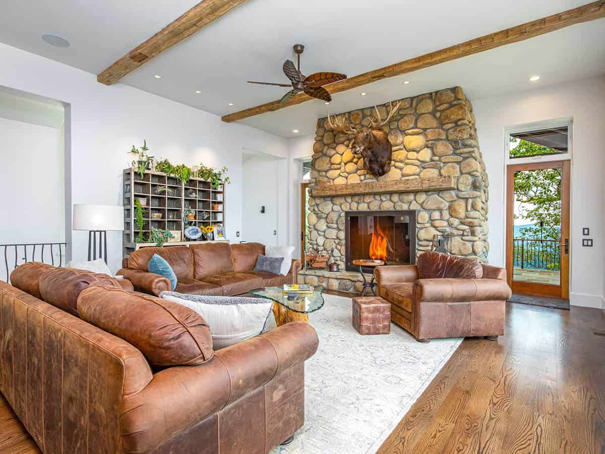 mountain ranch style living room with a fireplace