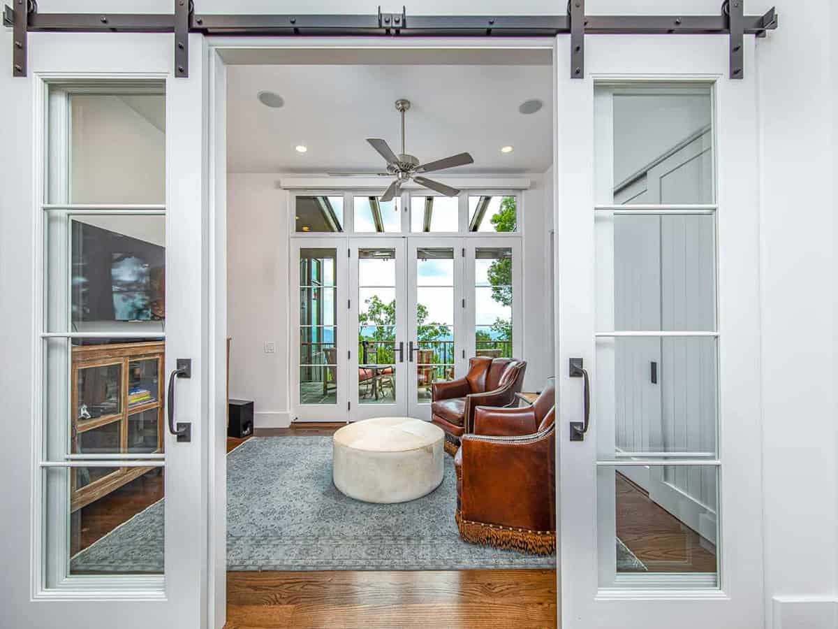 mountain ranch style home office with sliding barn doors