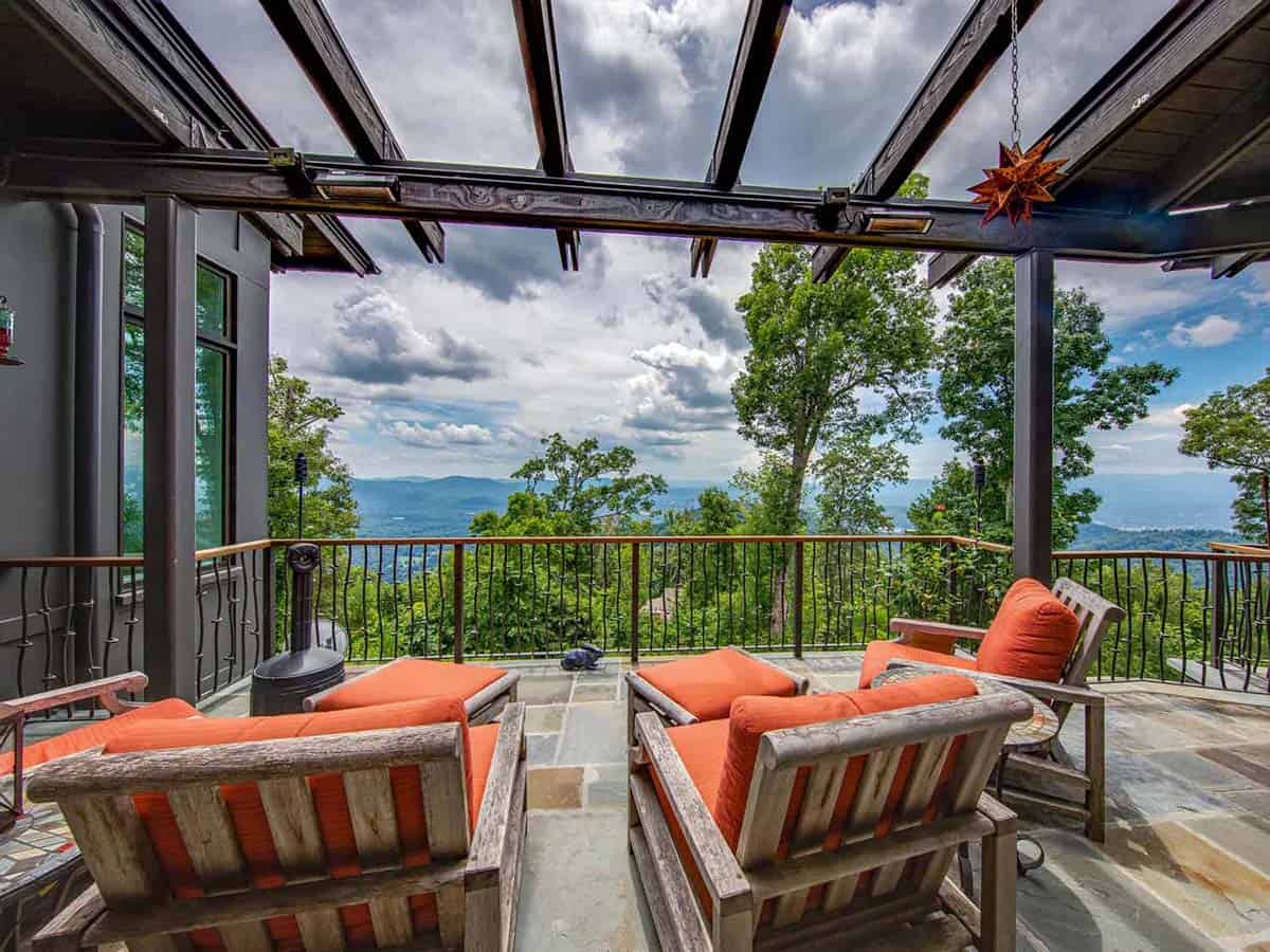 mountain ranch style home exterior with a covered patio