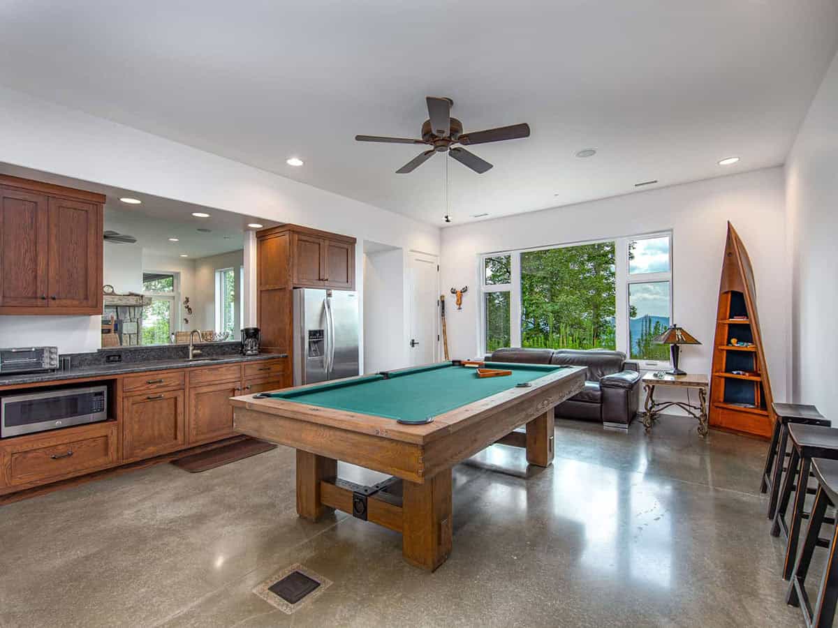 mountain ranch style lower level with a pool table