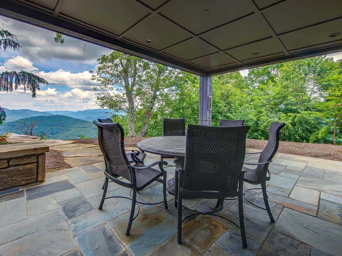 mountain ranch style home exteiror with a covered patio