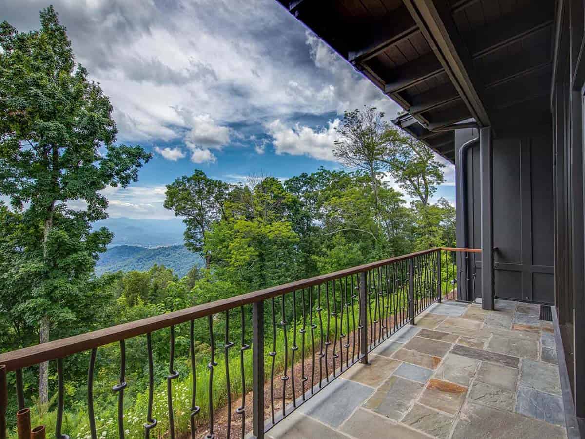 mountain ranch style home exteiror with a covered patio