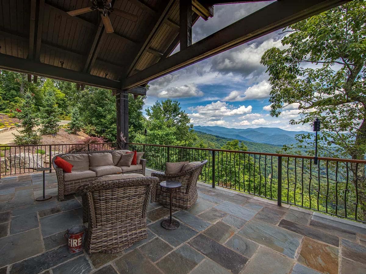 mountain ranch style home exteiror with a covered patio