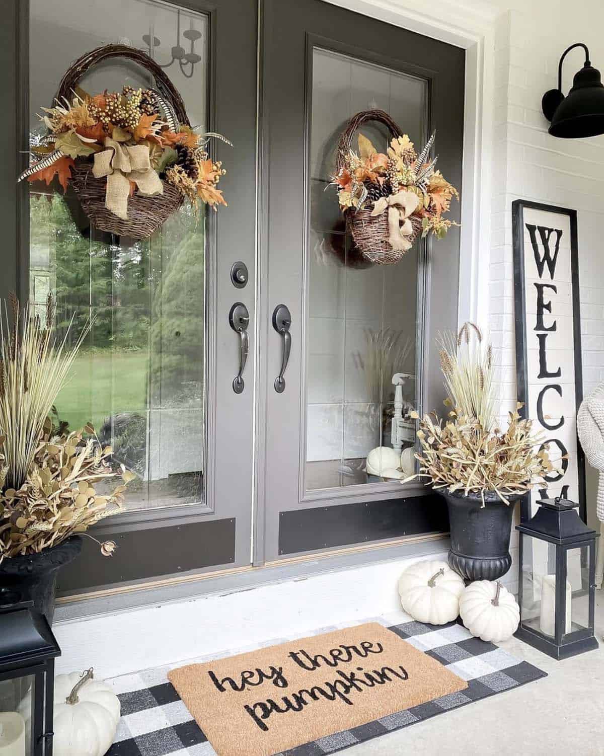 front door decorated for fall with a doormat and wreaths