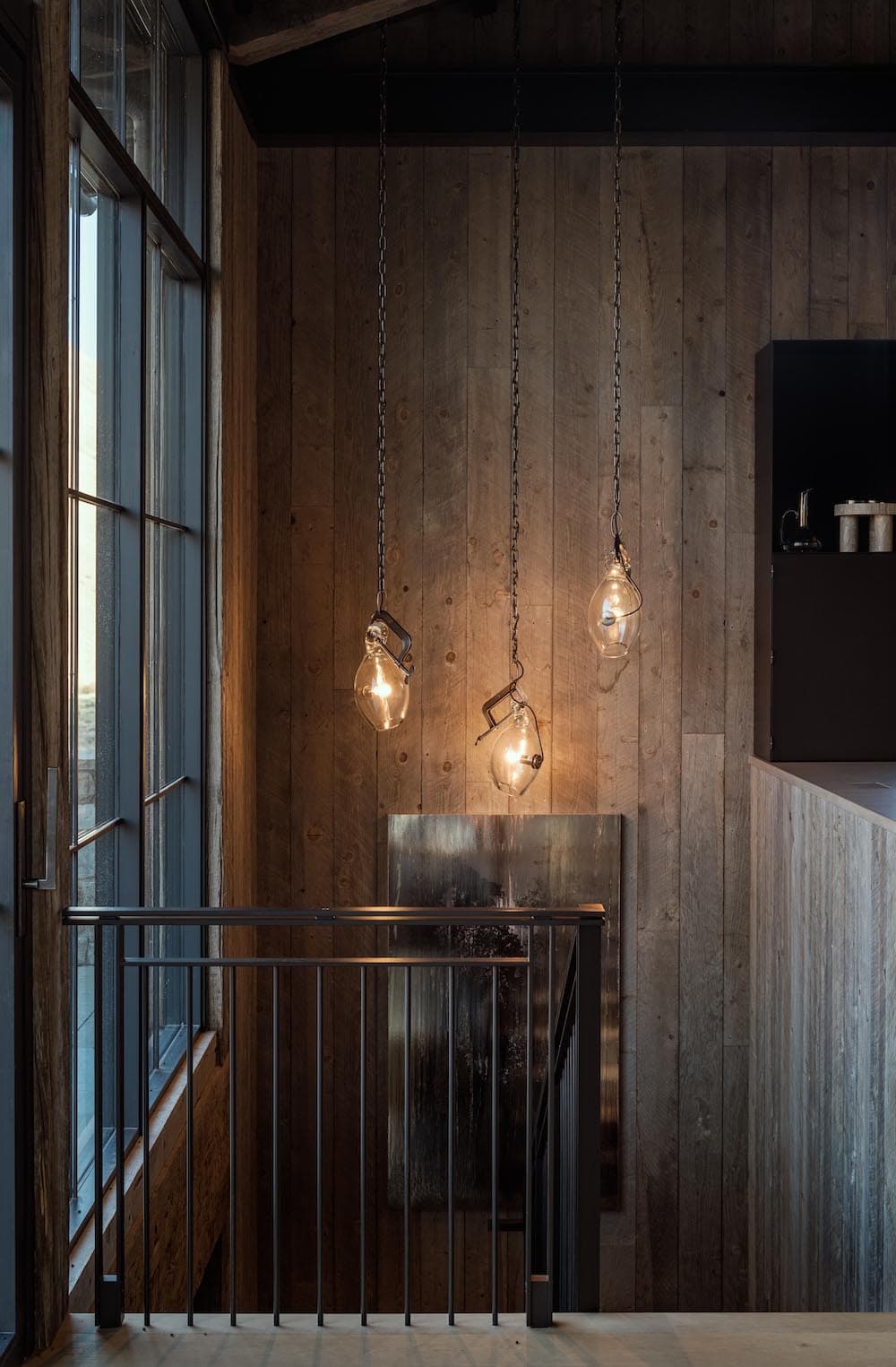 modern mountain style staircase with hand-blown glass lighting