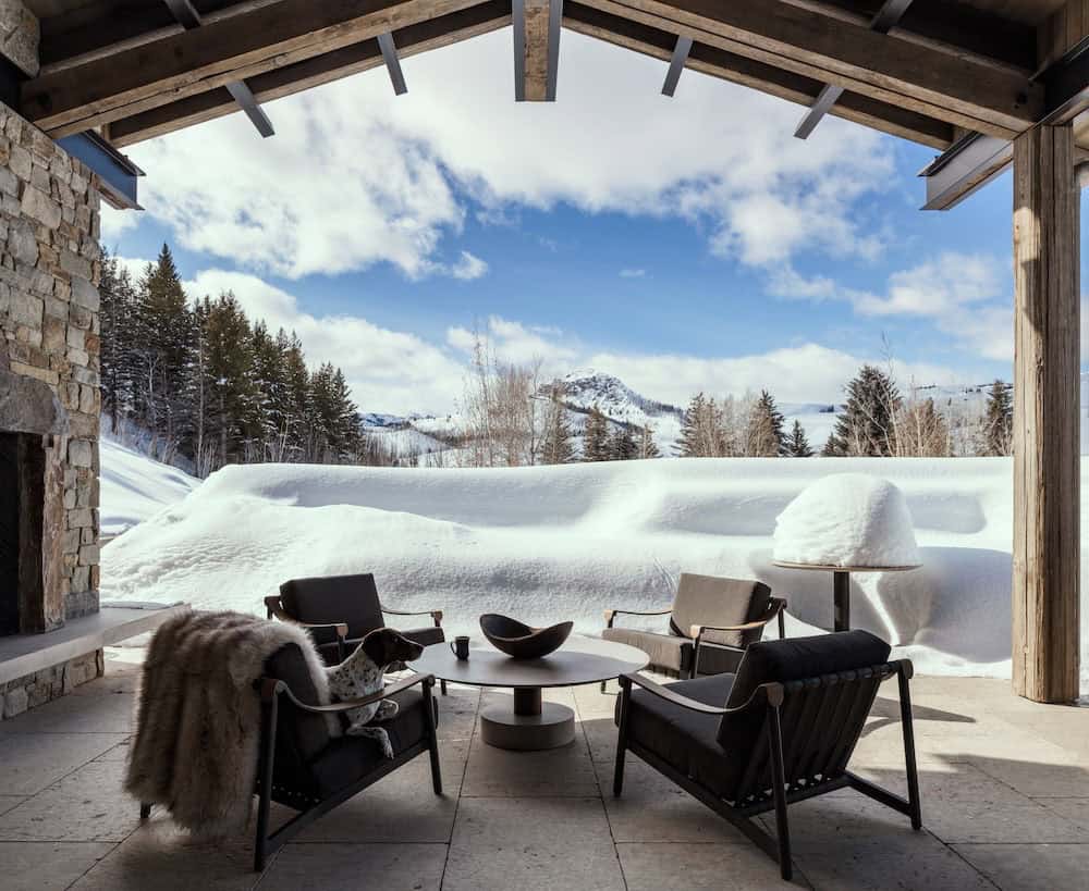 modern mountain style covered porch with outdoor furniture