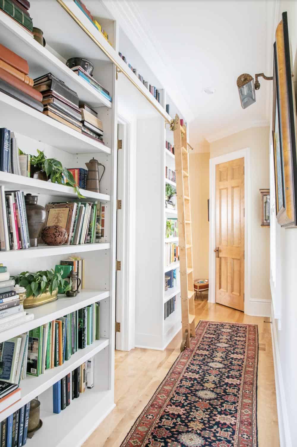traditional style hallway with built-in bookshelves