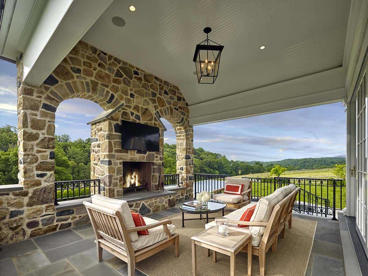 traditional covered porch with a fireplace