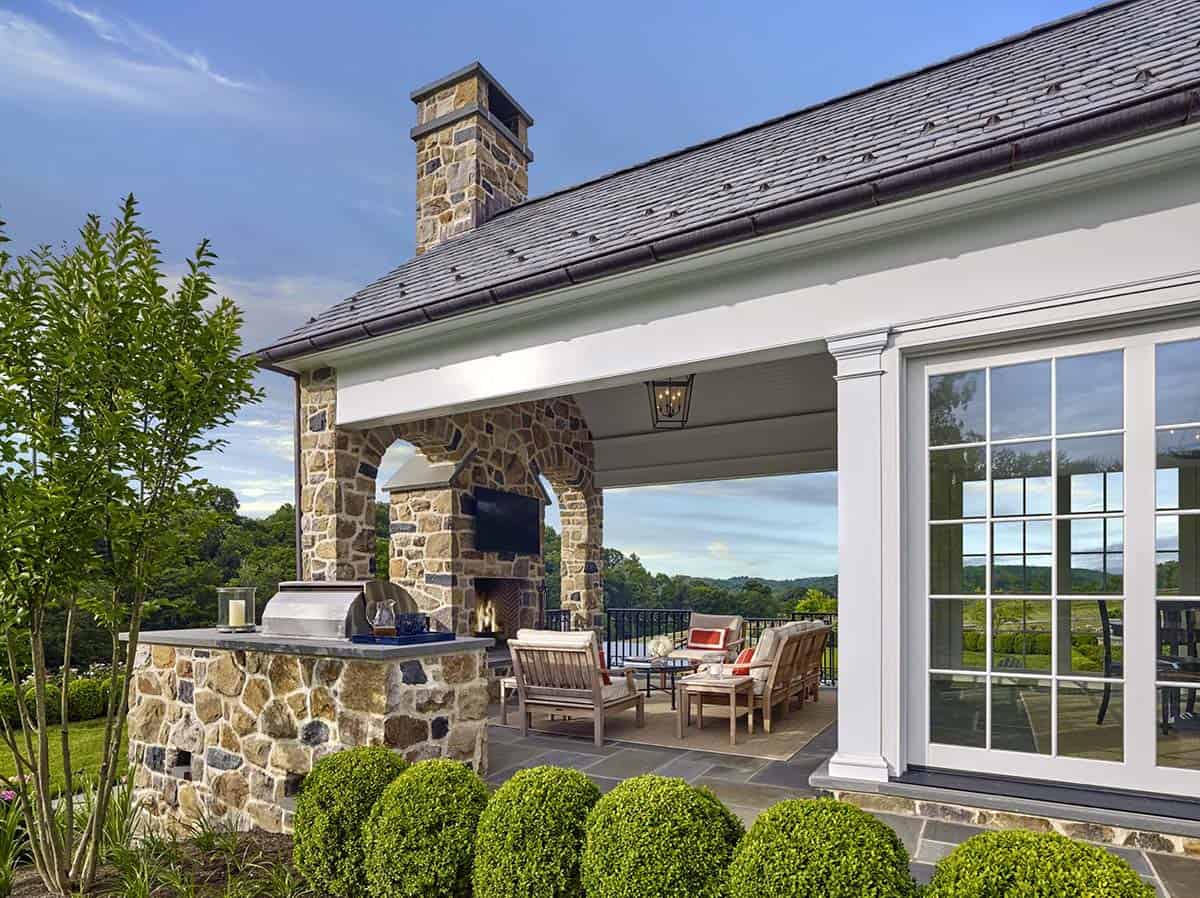 traditional covered porch with a fireplace