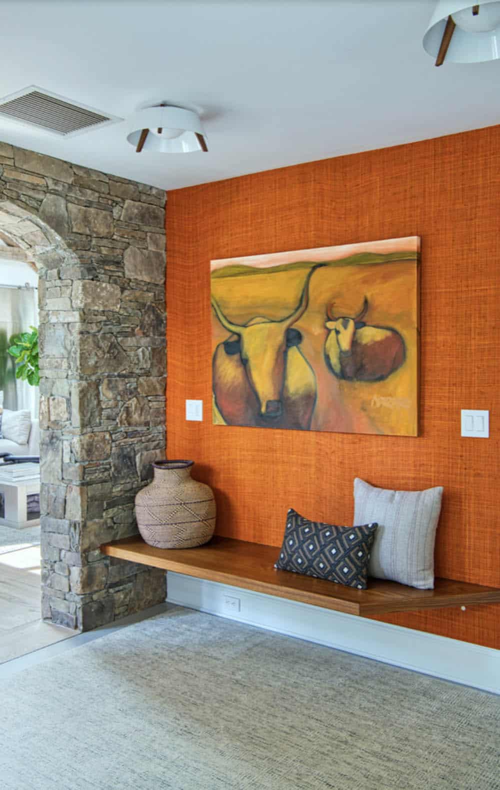 transitional style home entry with a bench
