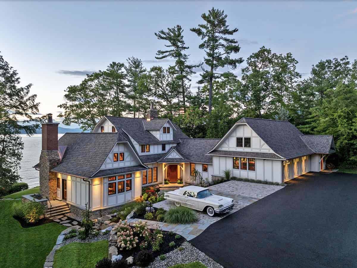 tudor style lake house exterior at dusk