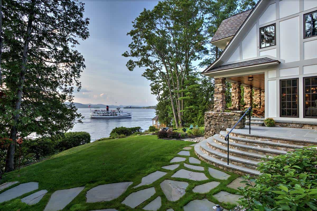 tudor style lake house exterior with a lake view