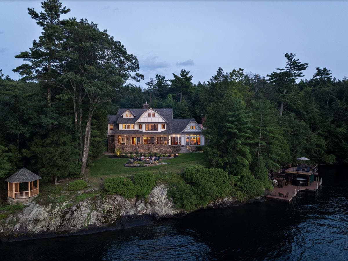 tudor style lake house exterior at dusk