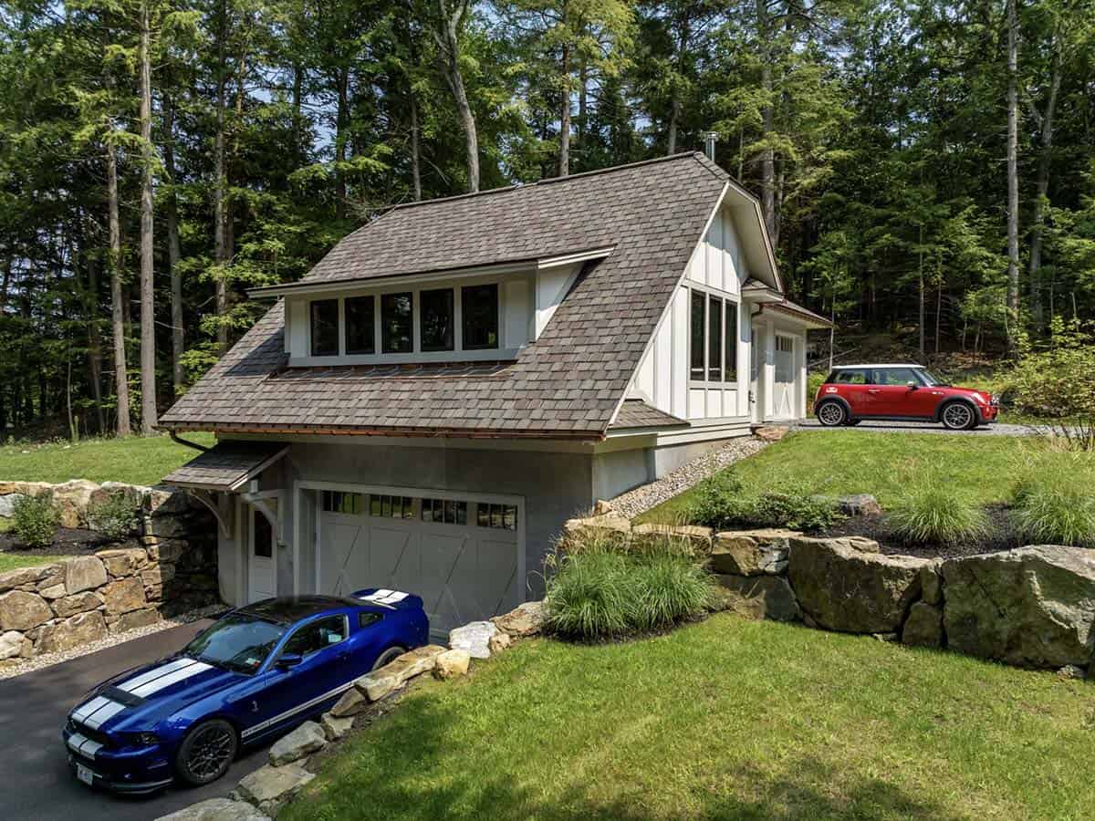 tudor style lake house exterior with a garage